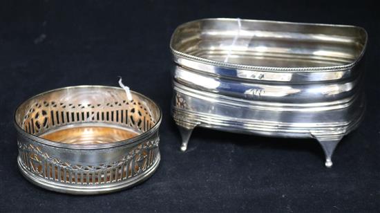 A George III silver cruet stand base, London 1807, (lacking fitments) and a later circular pierced wine coaster, Thomas Bradbury & Sons